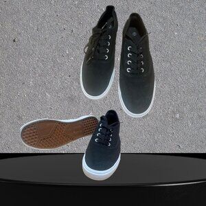 This is a pair of H&M Divided black canvas lace-up flat sneakers